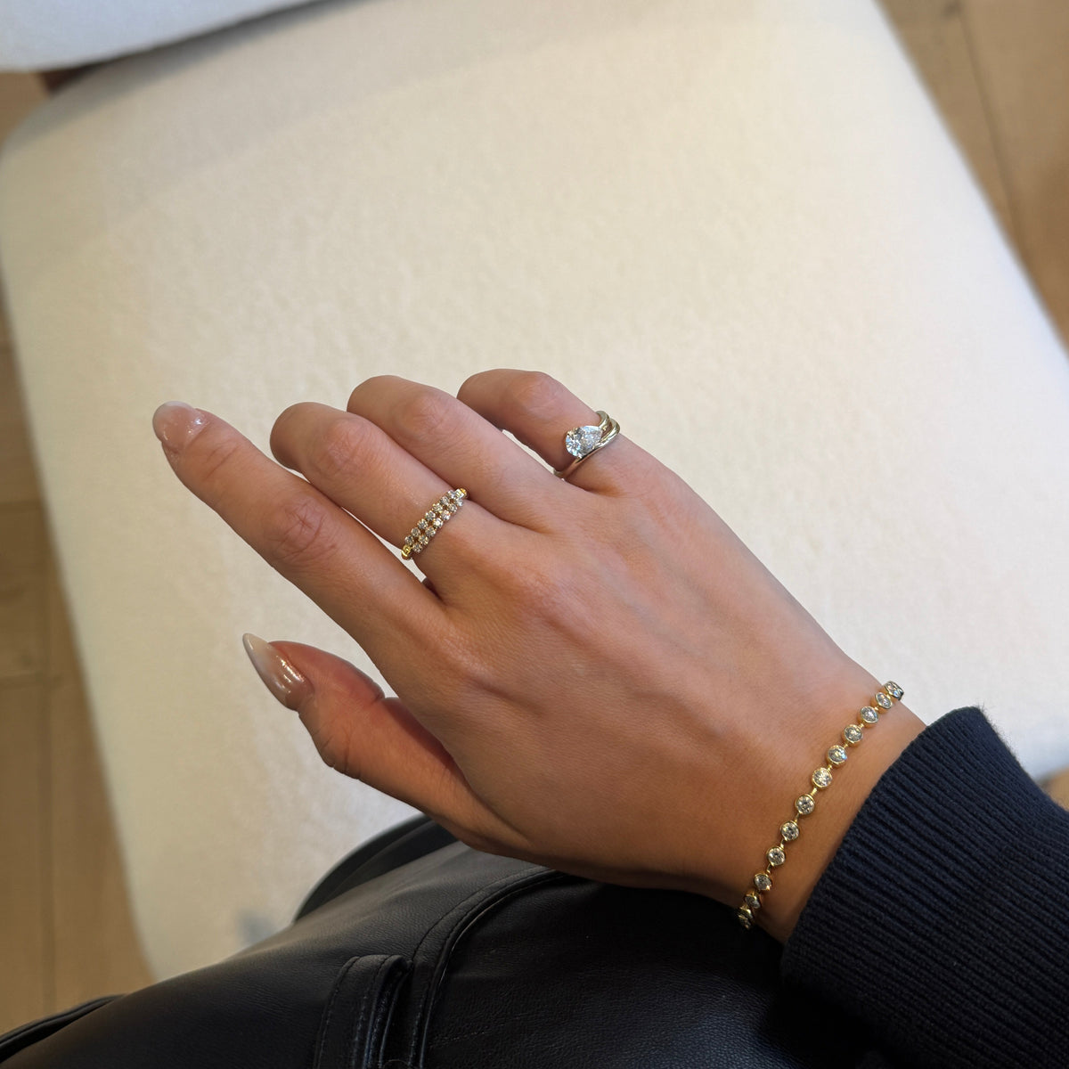 18K gold natural diamond flexible stretch ring featuring a continuous row of round brilliant-cut diamonds, styled on the hand.