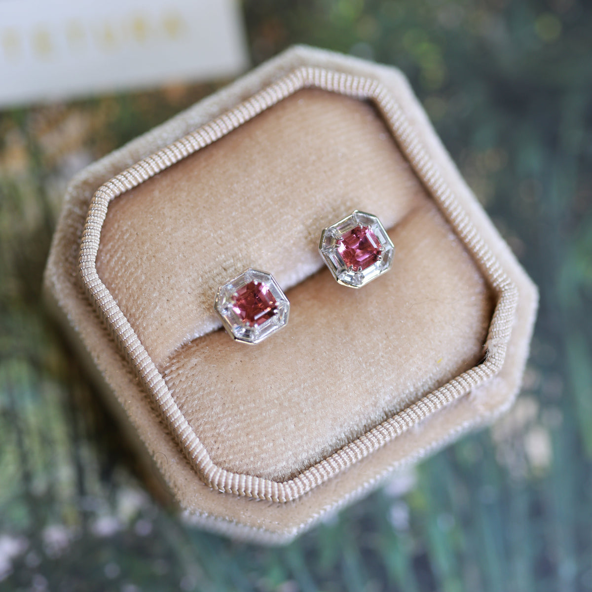 18K white gold stud earrings featuring natural pink tourmaline center stones surrounded by geometric lab-grown baguette-cut diamonds in an elegant octagonal halo design.