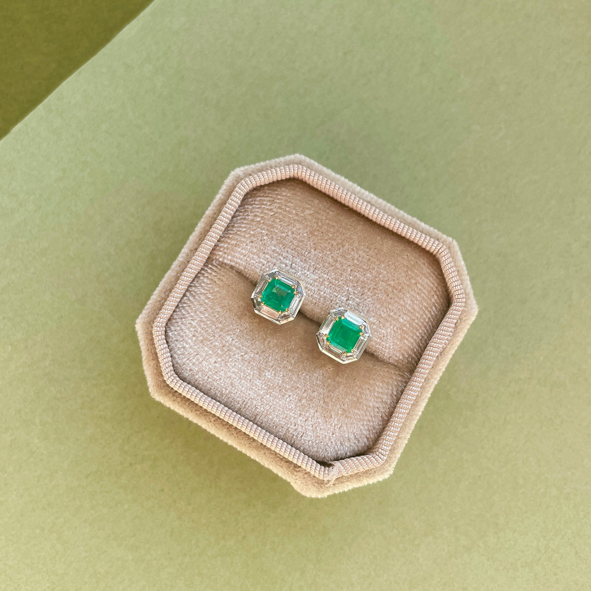 18K white gold stud earrings featuring natural Panjshir emeralds surrounded by geometric lab-grown diamonds in an elegant octagonal halo design.