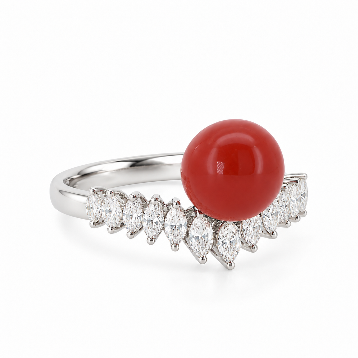 Angled view of an 18K white gold ring featuring a round AKA Red Coral cabochon cradled by a curved tiara band of marquise-cut diamonds.