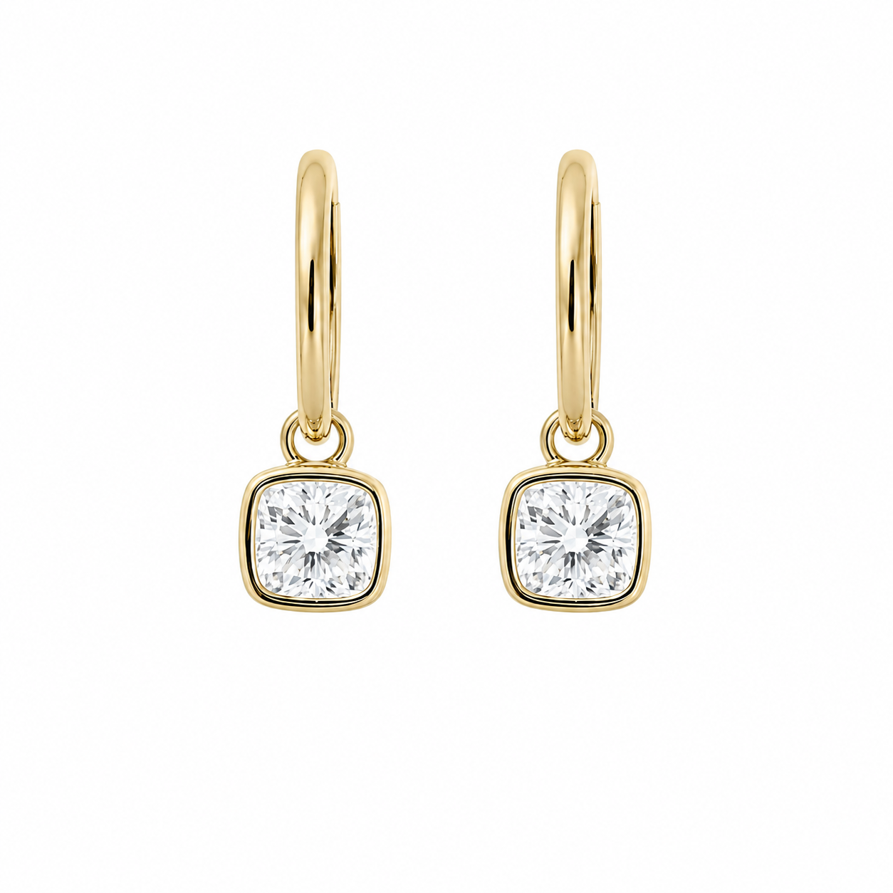 A pair of modern 18K yellow gold fine jewelry huggie hoop earrings, each featuring a dangling 1-carat cushion-cut lab-grown diamond center stone secured in a smooth bezel setting, isolated against a solid white background.