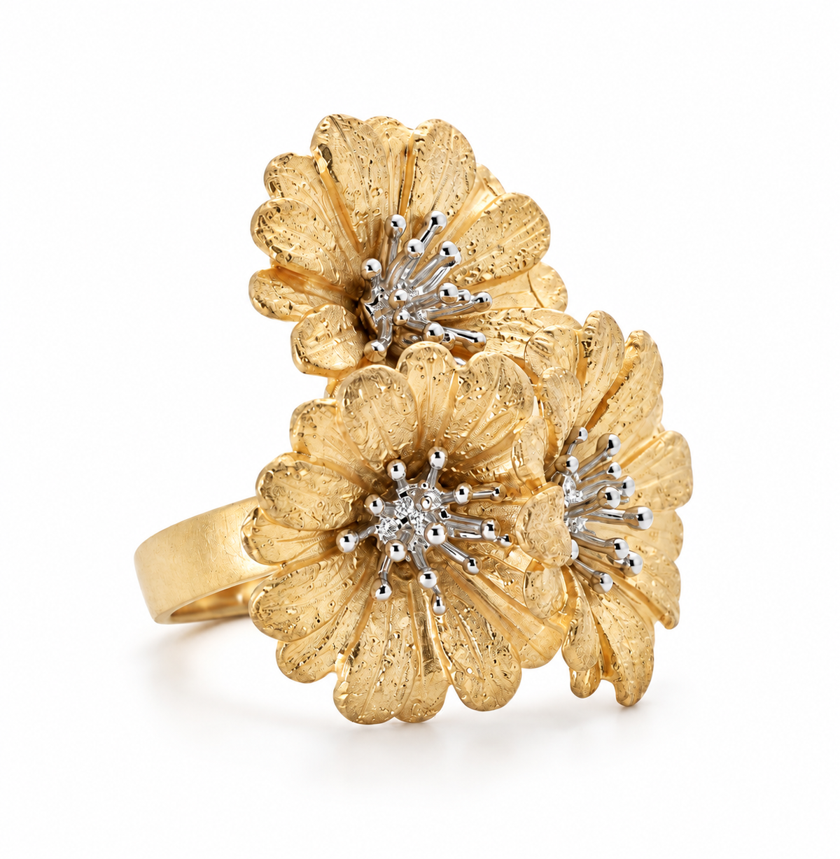 Angled view of an 18K gold vermeil statement ring showcasing three finely textured daisy blossoms and a smooth band.