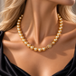 South Sea golden pearl necklace featuring lustrous round golden pearls with rich warm overtones, finished with an elegant floral gold clasp accented by a sparkling diamond.