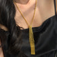Italian silver tassel necklace with a gold-tone finish, featuring an intricate woven mesh design and cascading chain fringe.
