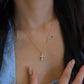 18K gold natural diamond cross necklace featuring a graduated diamond cross pendant with a smaller diamond cross accent set along the delicate gold chain.