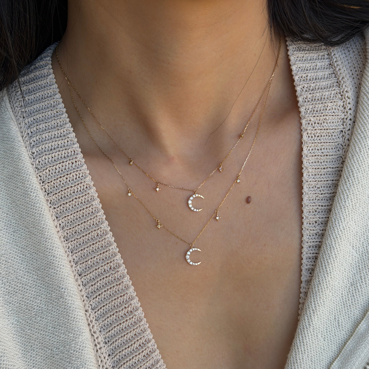 18K gold natural diamond crescent moon necklace featuring sparkling diamond-set moon pendants with delicate star and diamond accents, styled in a layered look.