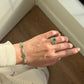 18K white gold emerald and natural diamond bracelet featuring oval-cut emeralds alternating with sparkling round brilliant-cut white diamonds in an elegant link design.