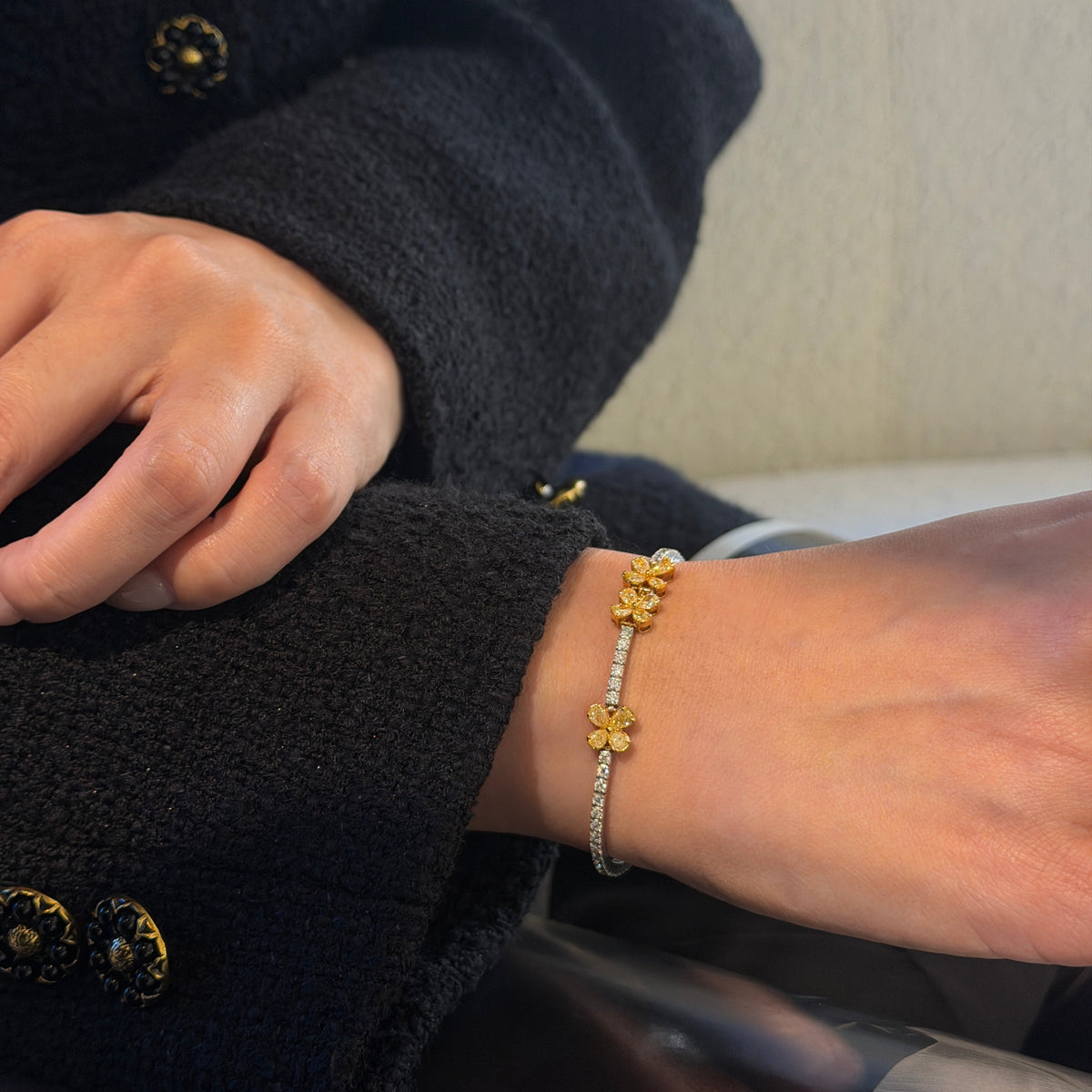 18K gold natural yellow and white diamond bracelet featuring pear-shaped yellow diamonds arranged in floral clusters with a sparkling row of white diamonds.