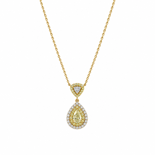 Studio shot of a luxurious 18K gold necklace featuring a ~0.31ct pear-shaped natural yellow diamond pendant with a double halo of colorless and yellow diamonds.