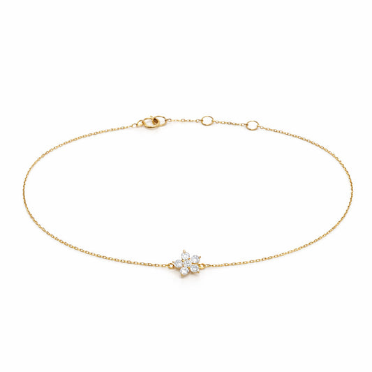 18K yellow gold petite floral bracelet featuring a five-petal diamond flower charm on a delicate adjustable cable chain.