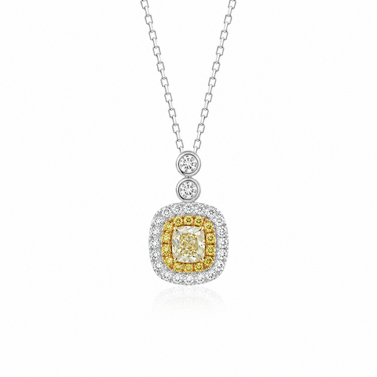 A 0.25ct natural yellow diamond pendant featuring a yellow and white diamond double halo, with two round diamond accents on the bail, suspended elegantly on an 18K white gold sparkle chain.