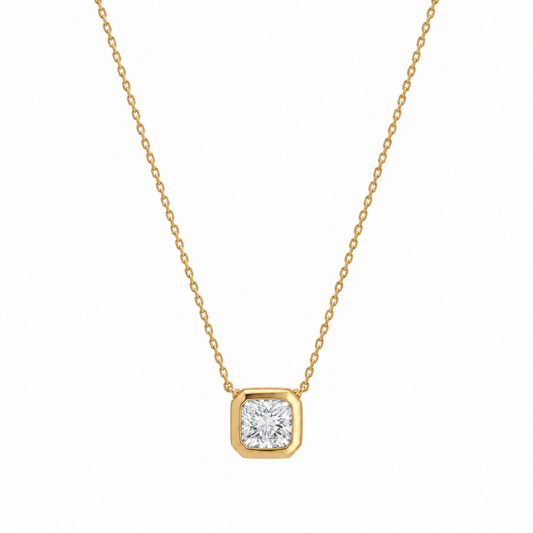 Studio shot of an 18K gold bezel set diamond necklace featuring a 1.02ct lab-grown diamond on a white background.