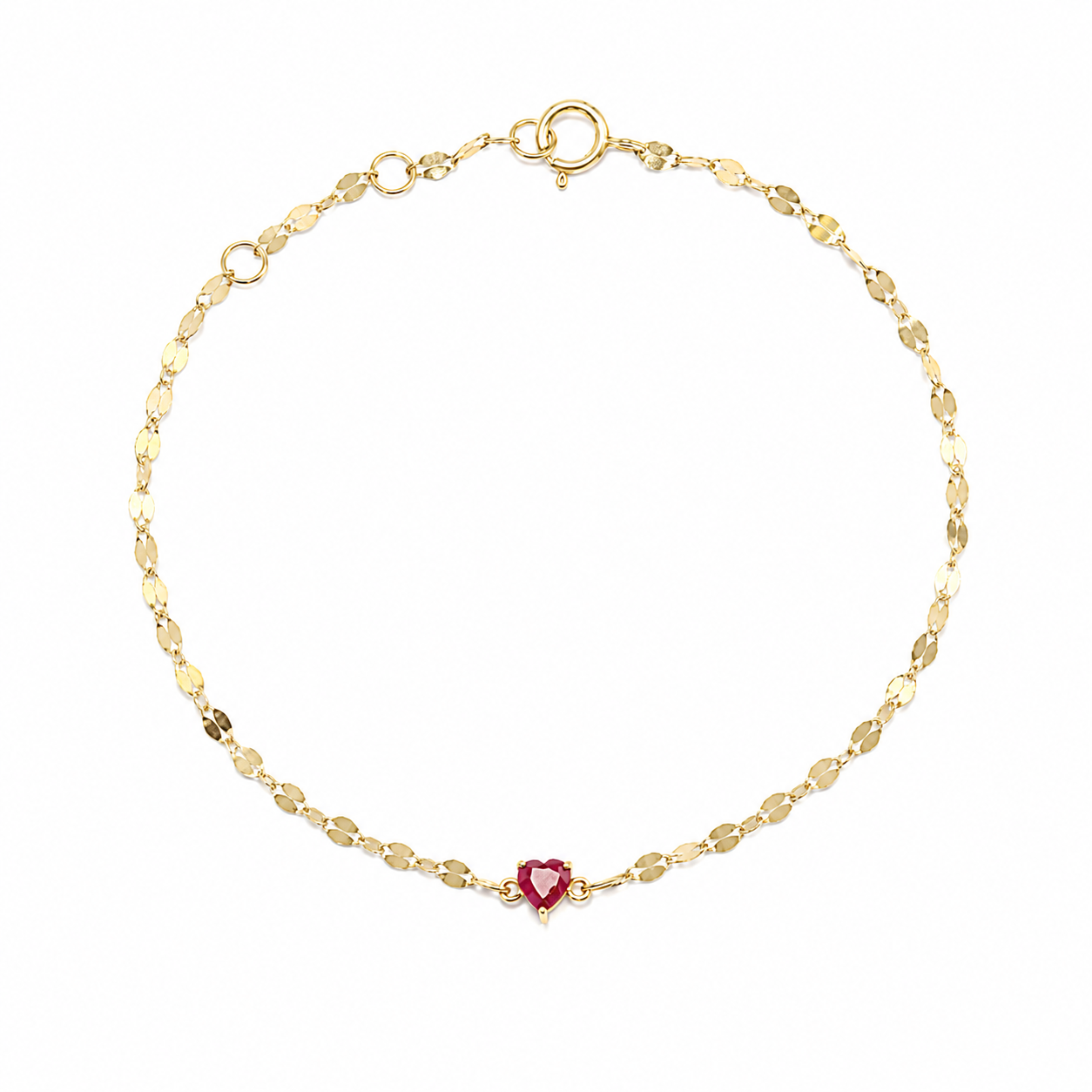 A minimalist 18K yellow gold fine jewelry bracelet featuring a small, vibrant heart-cut natural red ruby centered on a shimmering, textured Margarita chain against a solid white background.