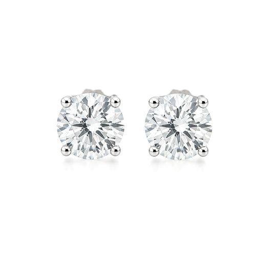 Pair of Fantasilvia round brilliant-cut diamond solitaire stud earrings in an 18K white gold four-prong setting, centered on a white background.