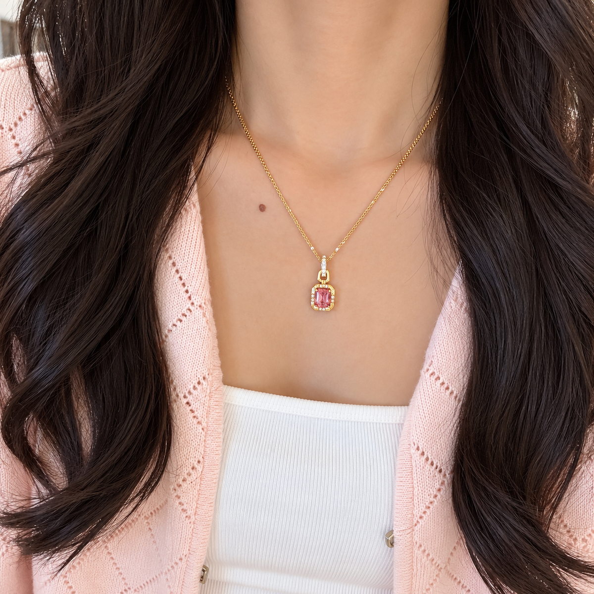 18K yellow gold pendant necklace featuring a natural emerald-cut pink tourmaline framed by sparkling natural colorless diamonds in a refined halo setting.