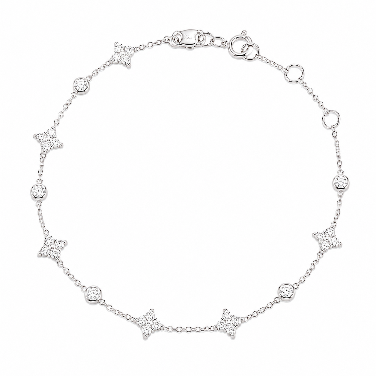 A delicate 18K white gold fine jewelry station bracelet featuring alternating pavé-set diamond four-leaf clovers and round bezel-set diamonds on a fine cable chain, isolated against a solid white background.