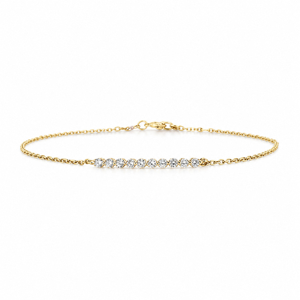 A delicate Fantasilvia 18K yellow gold chain bracelet featuring a horizontal bar of ten small round pavé diamonds on a white background.