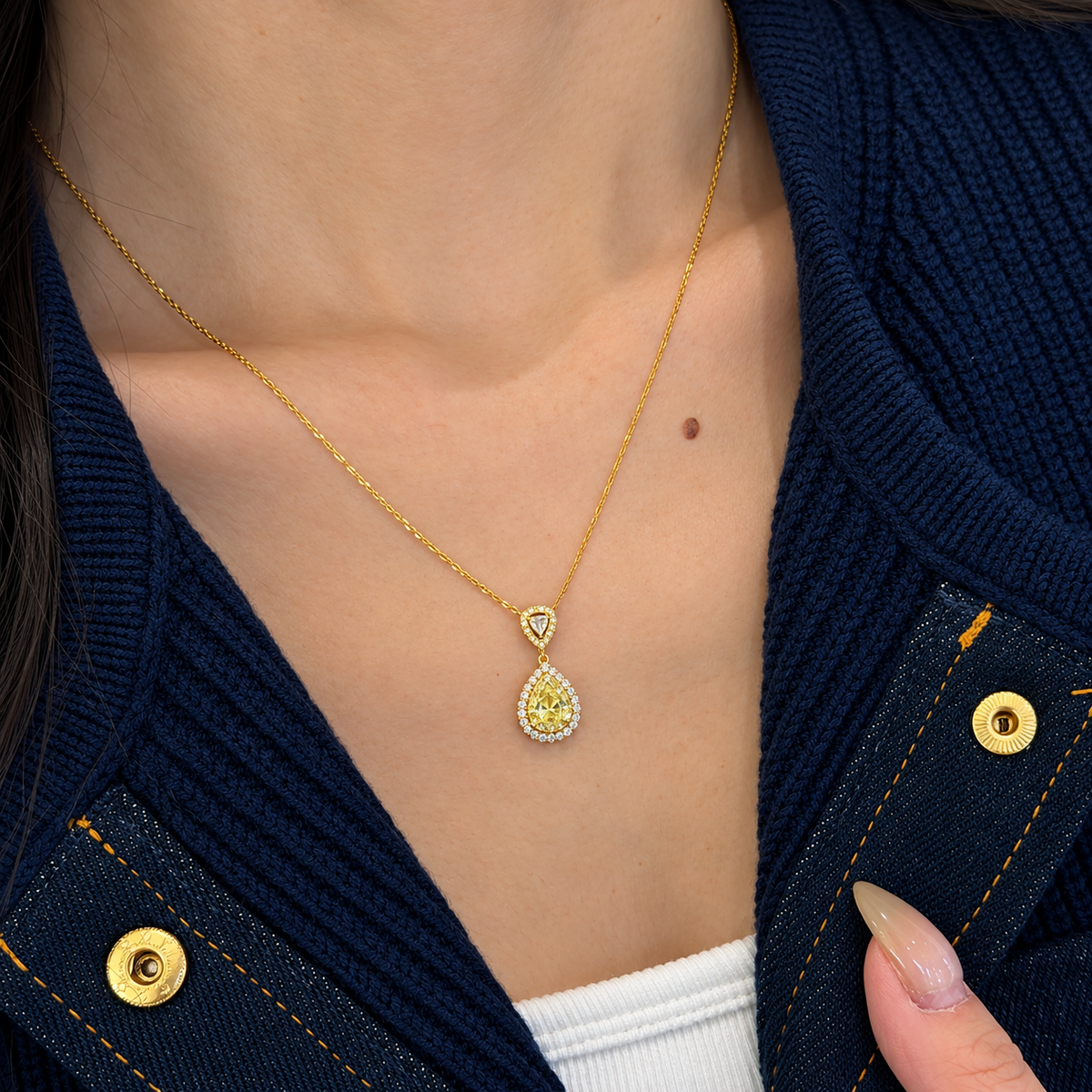 18K solid gold pendant necklace featuring a pear-cut natural yellow diamond center surrounded by natural colorless and fancy yellow diamond halos, finished with a trillion-style diamond accent and fine gold chain.