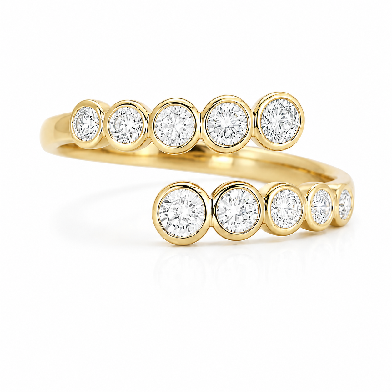Studio product shot of an 18K gold open wrap ring featuring bezel-set round lab-grown diamonds on a white background.