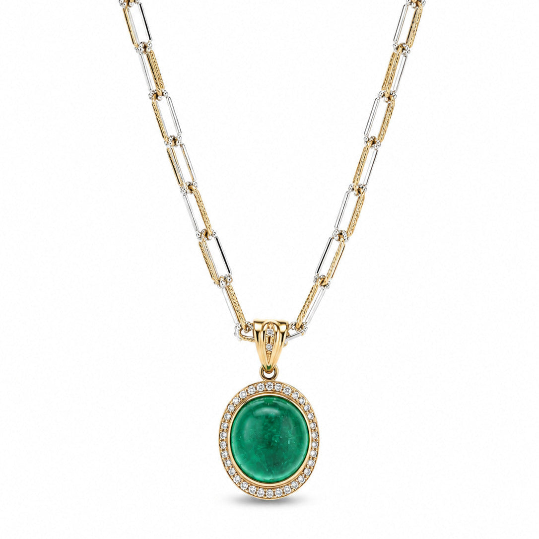 A luxury Fantasilvia necklace featuring a large 11.29ct oval green cabochon emerald pendant with a white diamond halo on a two-tone yellow and white gold paperclip chain.