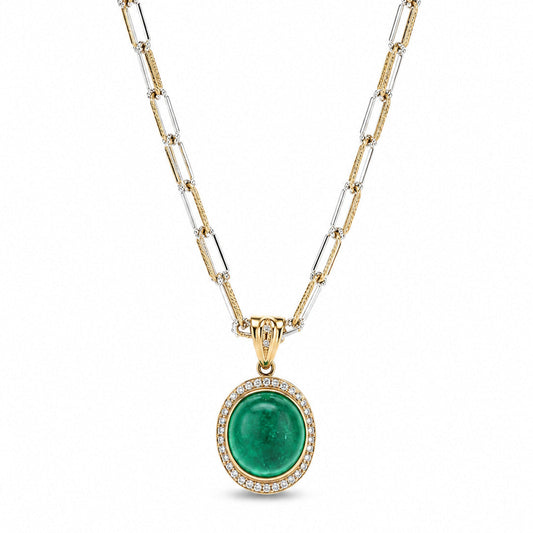 A luxury Fantasilvia necklace featuring a large 11.29ct oval green cabochon emerald pendant with a white diamond halo on a two-tone yellow and white gold paperclip chain.