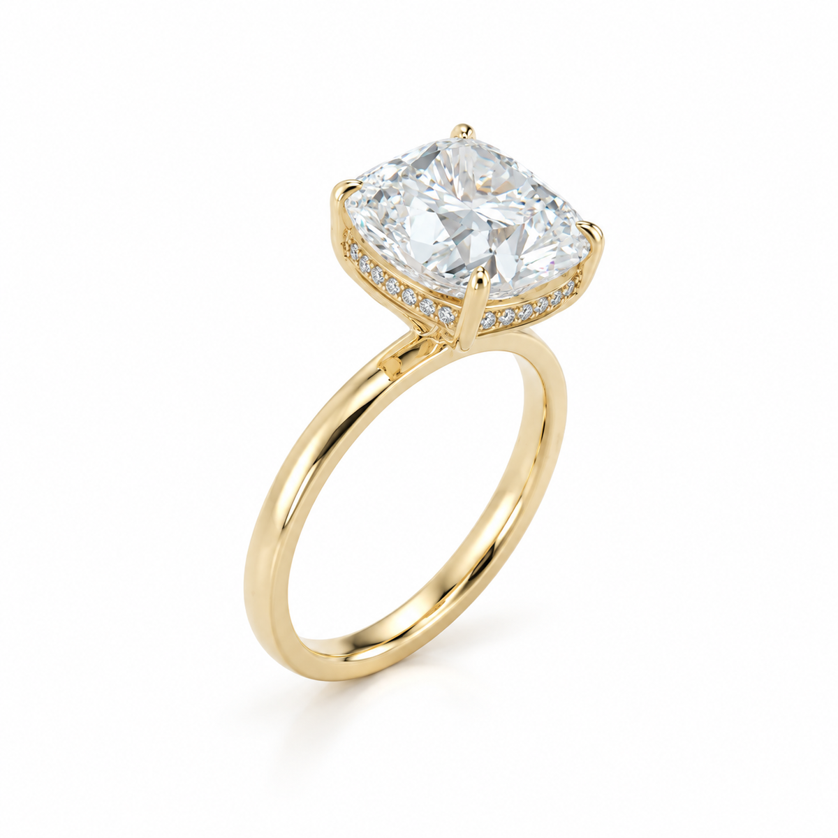 Angled view of a 14K yellow gold solitaire ring, showcasing a 3.08 carat cushion modified brilliant diamond and delicate pavé diamonds on the hidden halo gallery.