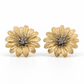 A pair of medium-sized, two-tone floral stud earrings shaped like blooming daisies, featuring multi-layered, textured gold vermeil petals and a contrasting silver-colored center stamen, shown on a white background.
