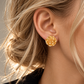 Italian silver rose stud earrings featuring a sculptural full-bloom design with richly textured layered petals and a warm golden finish.