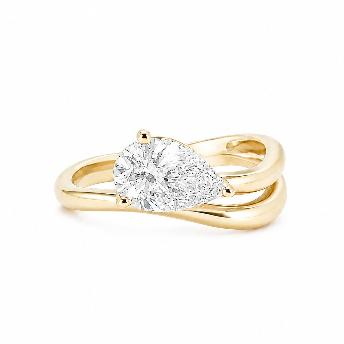 A 14K yellow gold fashion ring on a crisp white background. The ring features a prominent, brilliant pear-cut lab-grown diamond set horizontally across a high-polished gold band that splits and curves into an organic, fluid wave shape around the gemstone, perfectly proportioned for styling as a pinky ring.