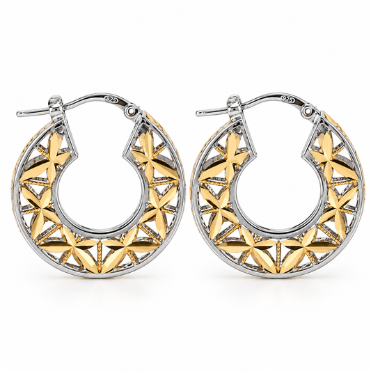 Front view of the Stella Fiorita two-tone hoop earrings featuring a polished 925 sterling silver outer frame and an intricate openwork gold vermeil floral star pattern.