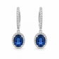 Front view of 18K white gold drop earrings featuring oval natural blue sapphires surrounded by colorless diamond halos on a white background.