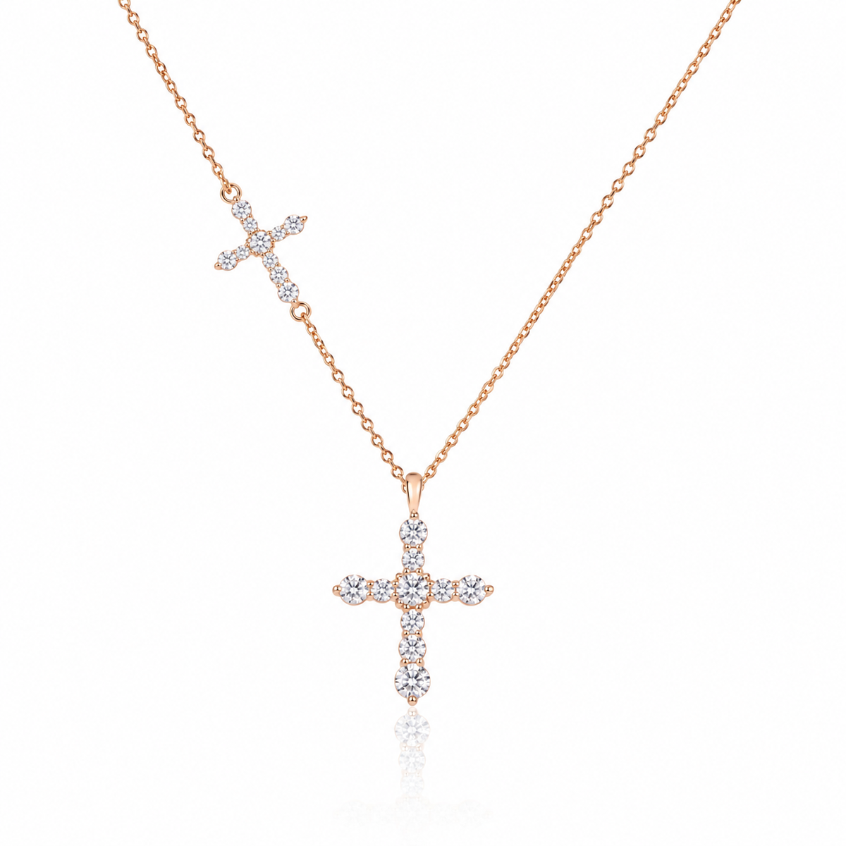 18K gold natural diamond cross necklace featuring a graduated round brilliant-cut diamond cross pendant and a smaller diamond cross accent on a delicate gold chain.