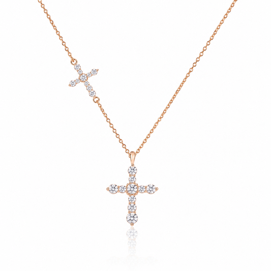 18K gold natural diamond cross necklace featuring a graduated round brilliant-cut diamond cross pendant and a smaller diamond cross accent on a delicate gold chain.
