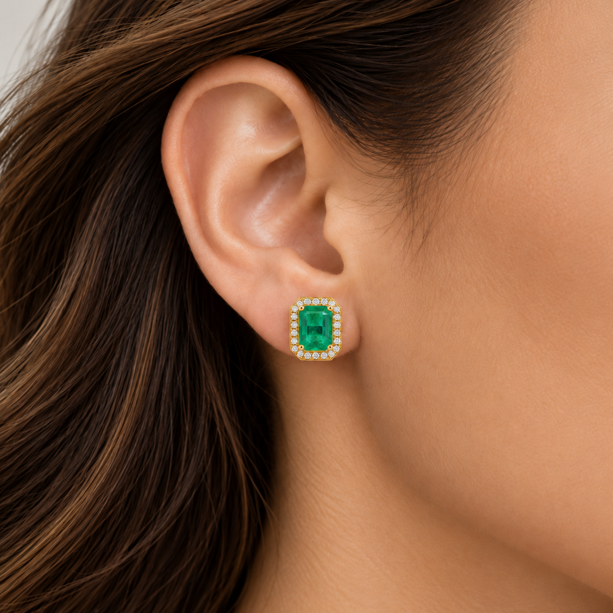 14K yellow gold emerald stud earrings featuring natural emerald center stones surrounded by brilliant lab-grown diamonds in a classic halo setting.