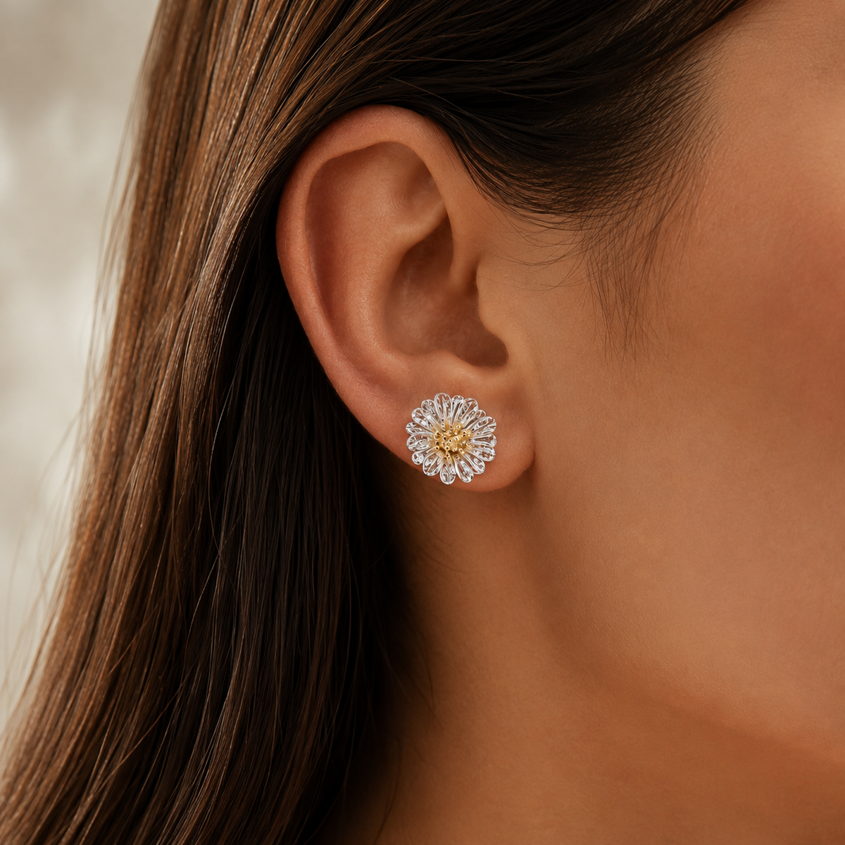 Italian silver floral stud earring featuring delicate filigree petals and a gold-tone center, elegantly styled on the ear.