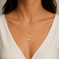 Italian silver floral pendant necklace featuring delicate gold-tone flowers with sparkling crystal centers, styled on a fine chain