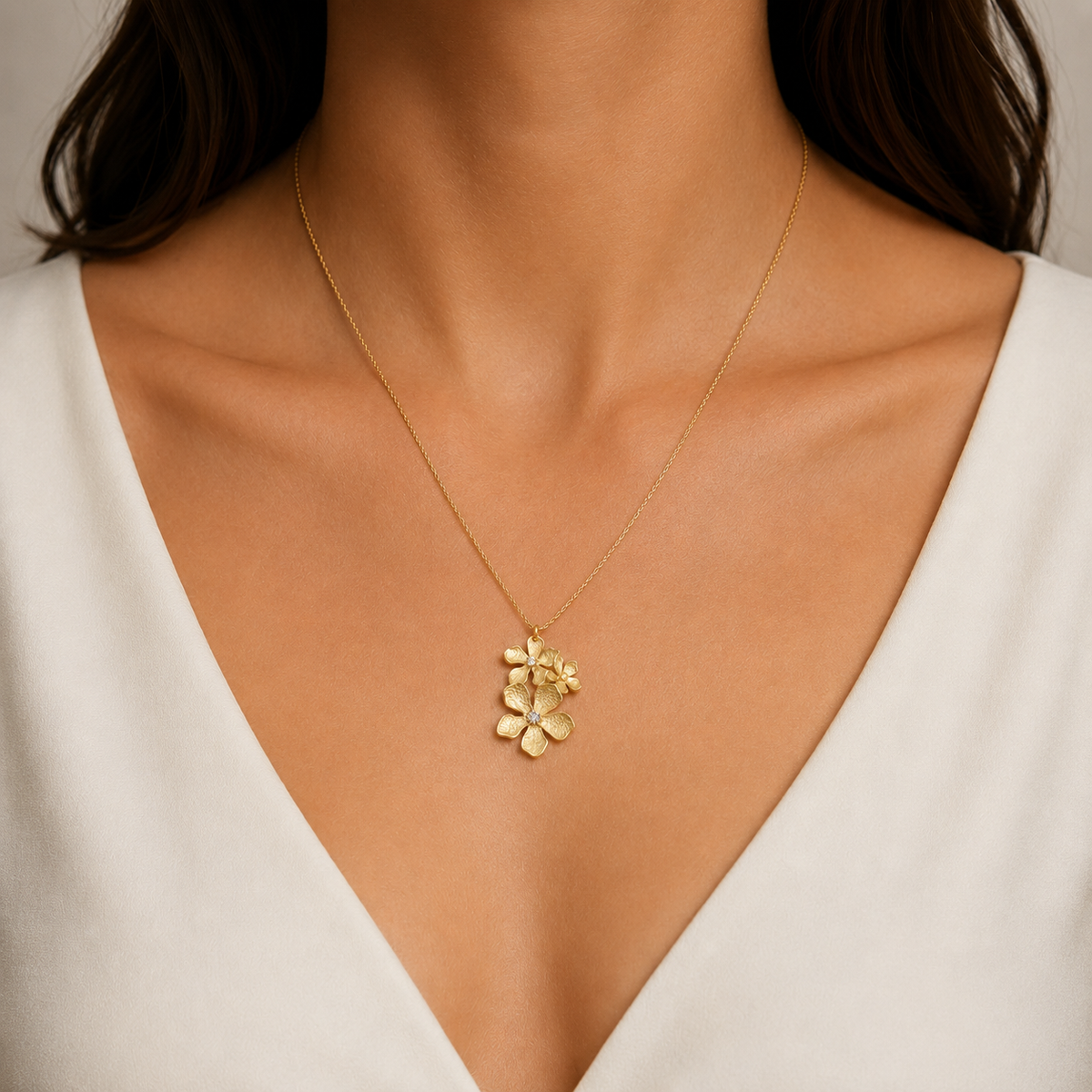 Italian silver floral pendant necklace featuring delicate gold-tone flowers with sparkling crystal centers, styled on a fine chain