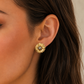 Italian silver floral stud earring with a gold-tone finish, featuring layered textured petals and a delicate silver center, styled on the ear.