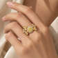 18K gold natural diamond statement ring featuring a fancy yellow center diamond surrounded by a halo of white diamonds and intricate floral diamond accents.