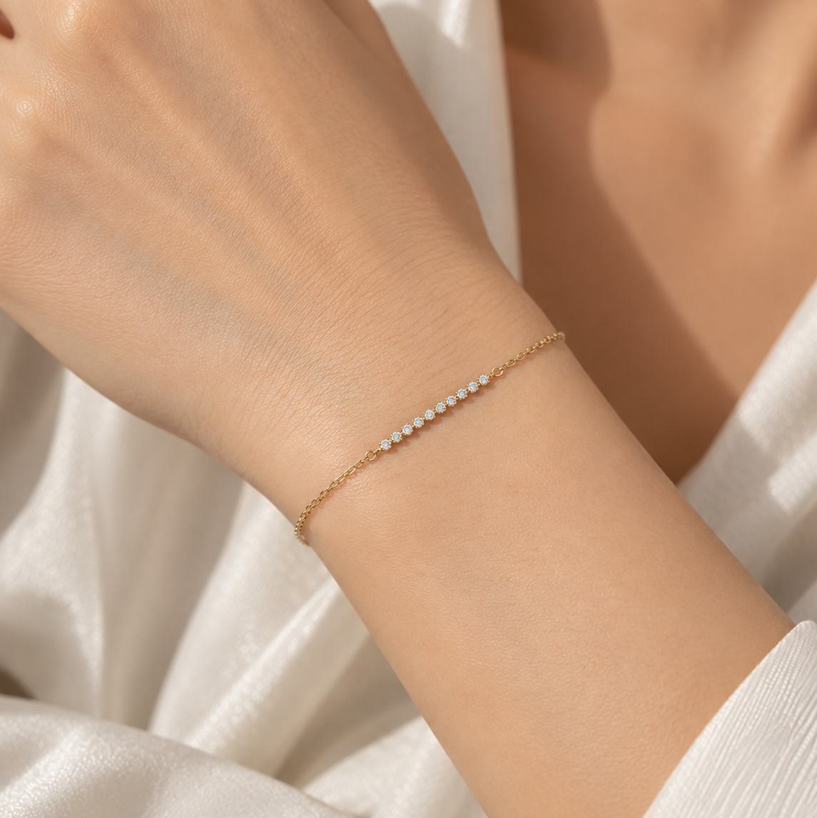 18K gold lab-grown diamond bracelet featuring a delicate row of round brilliant-cut diamonds set along a fine gold chain.