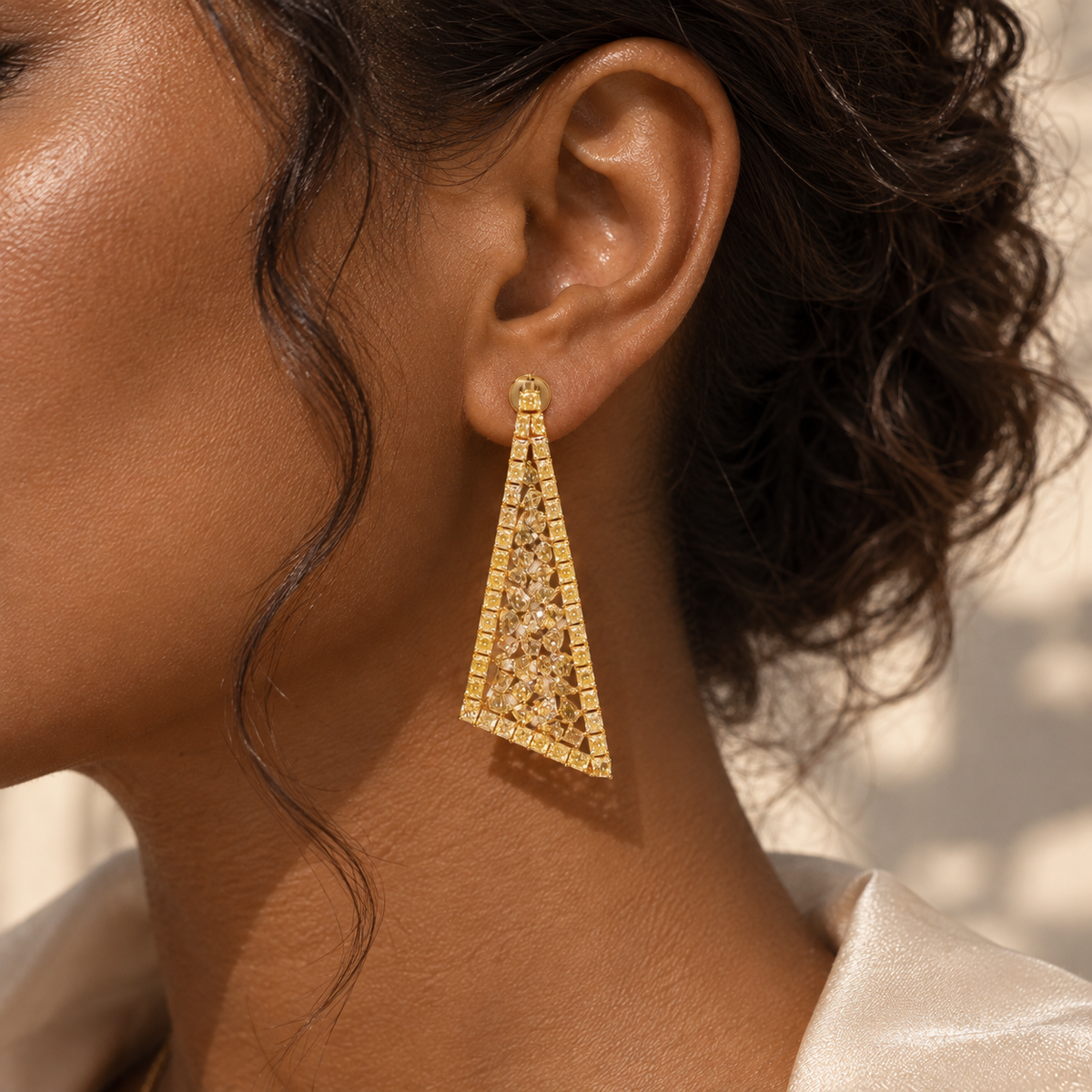 18K gold natural diamond statement earrings featuring an elongated triangular openwork design with intricate geometric details and sparkling diamond accents.