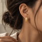 Italian 18K gold hoop earrings featuring a wide textured ribbed design with a bold sculptural silhouette.