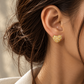 18K yellow gold heart stud earrings featuring a textured woven design accented with natural colorless diamonds, from the Golden Harmony Hearts collection.