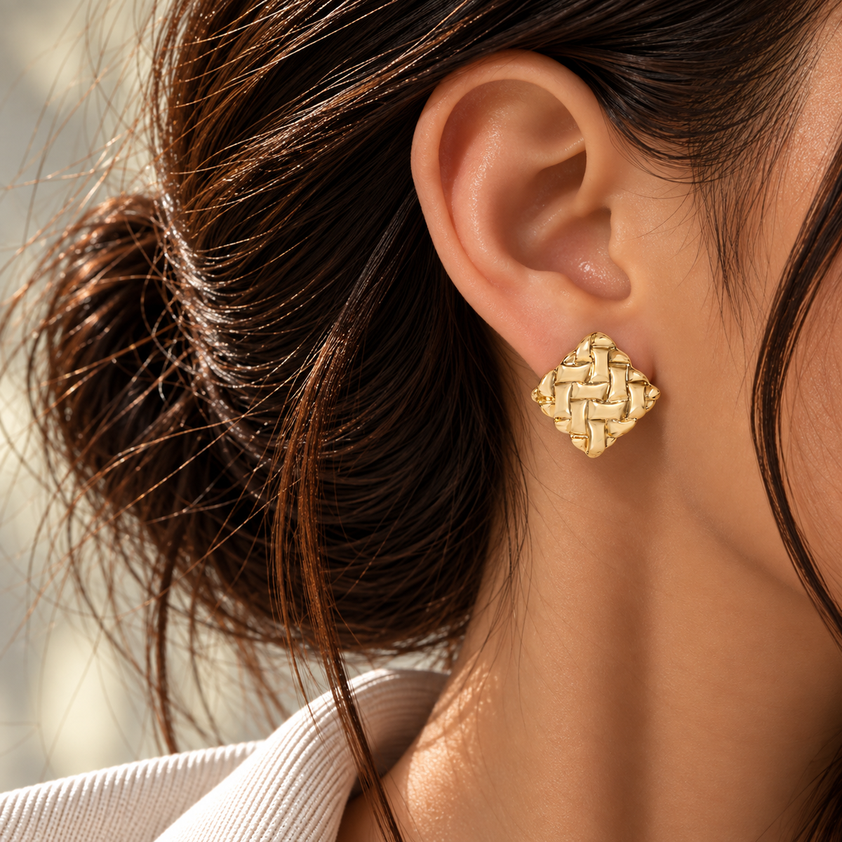 18K yellow gold statement stud earrings featuring a bold woven basket design with a smooth high-polish finish and sculptural square silhouette.
