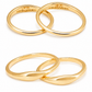 Studio shot of 18K gold matching couple rings showing the smooth curved exterior and secret custom initials MY and BX engraved inside.