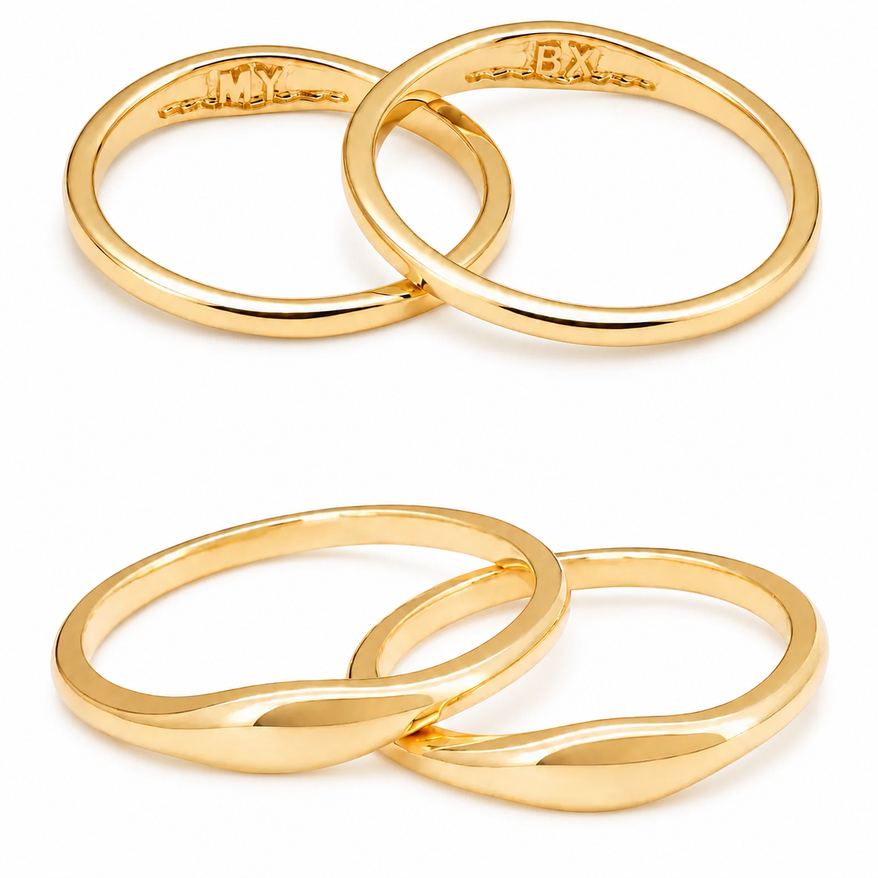 Studio shot of 18K gold matching couple rings showing the smooth curved exterior and secret custom initials MY and BX engraved inside.