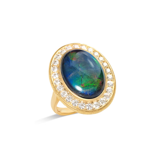 Natural ammolite halo ring with diamond surround by Fantasilvia Fine Jewelry.
