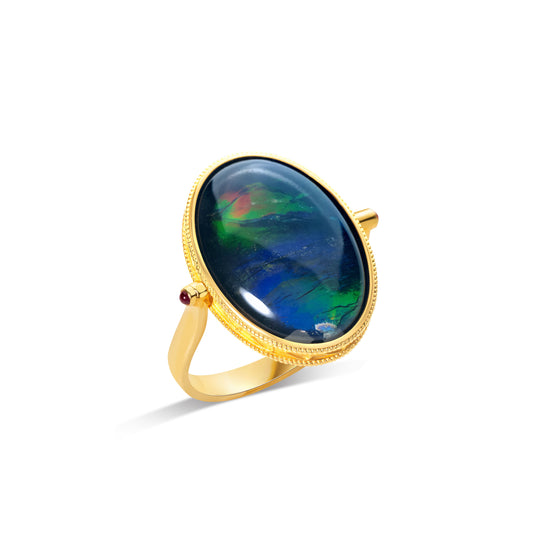 Oval ammolite ring in gold bezel setting with natural gemstone by Fantasilvia Fine Jewelry.
