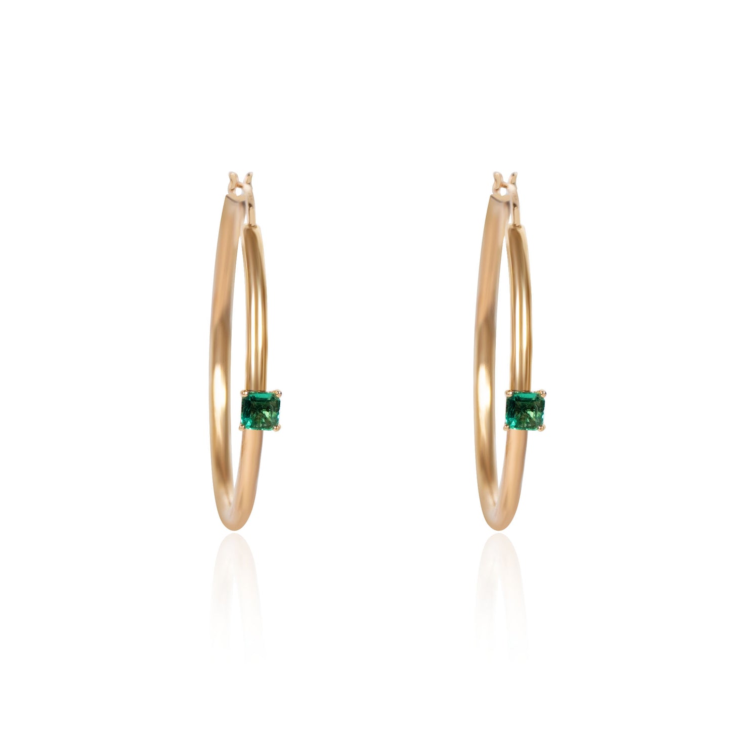 Natural emerald hoop earrings crafted in gold by Fantasilvia Fine Jewelry.
