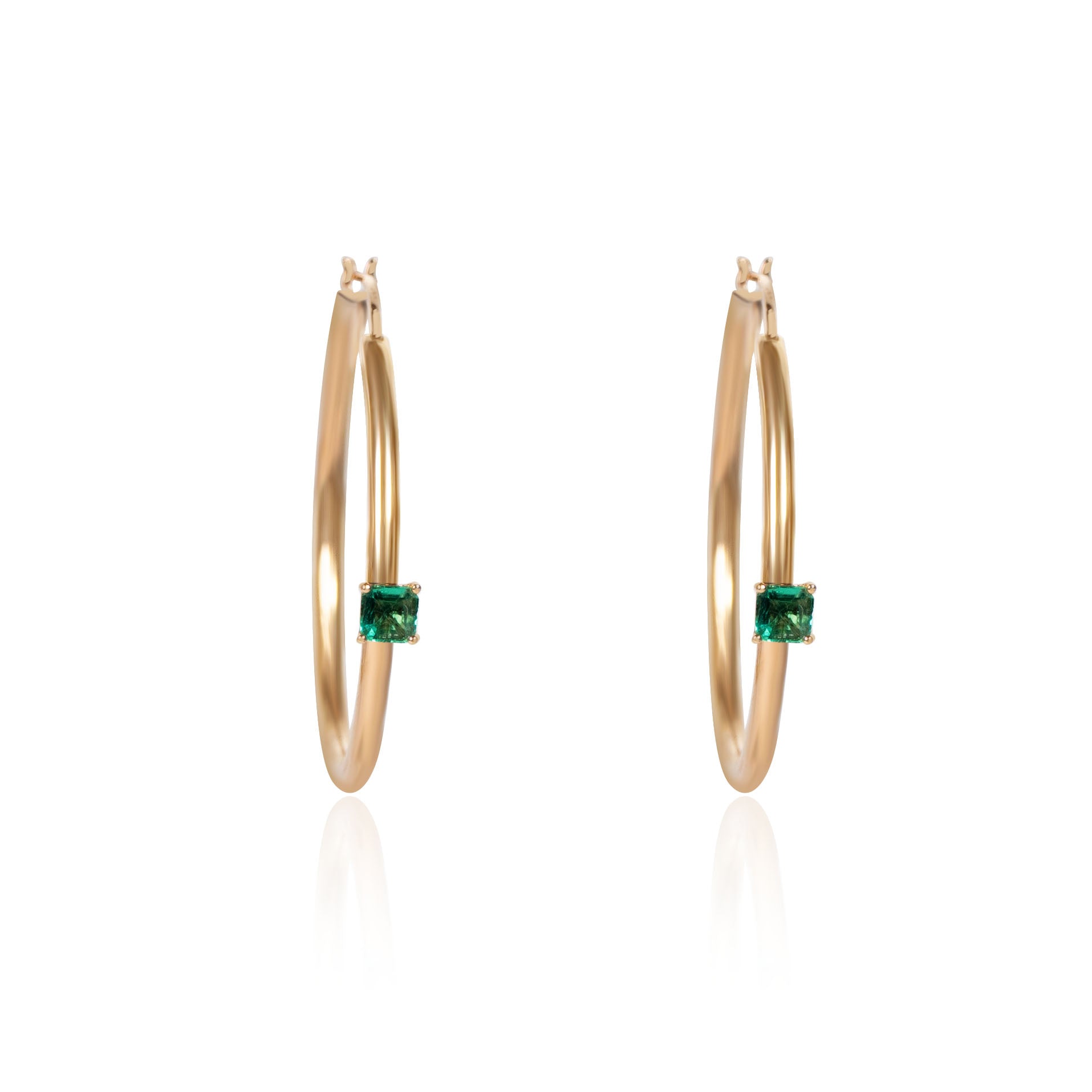 Natural emerald hoop earrings crafted in gold by Fantasilvia Fine Jewelry.
